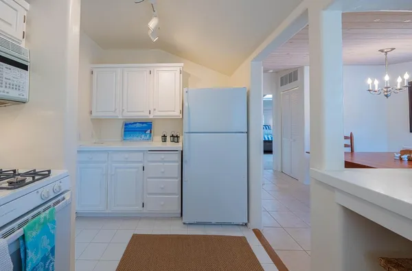 a kitchen with cabinets appliances and a counter space