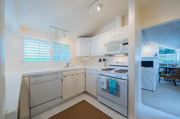 a kitchen with cabinets appliances and a window
