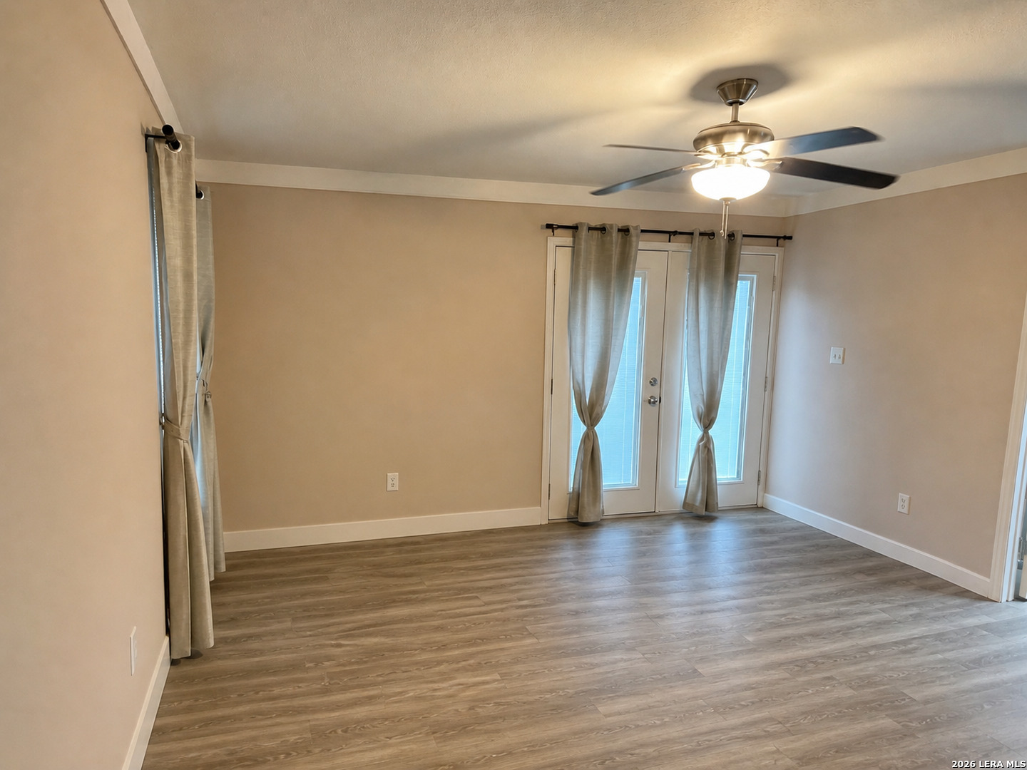 118 Stonegate South, Unit 2 Boerne, TX 78006 - Photo 4 of 7 a view of an empty room with wooden floor and a window