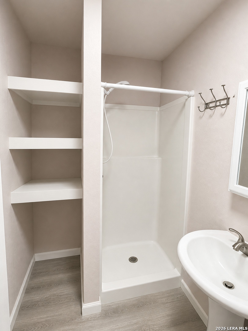 118 Stonegate South, Unit 2 Boerne, TX 78006 - Photo 5 of 7 a bathroom with a shower and a sink