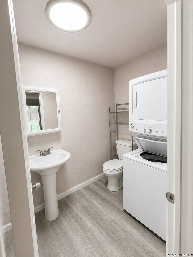 118 Stonegate South, Unit 2 Boerne, TX 78006 - Photo 6 of 7 a bathroom with a toilet sink and mirror