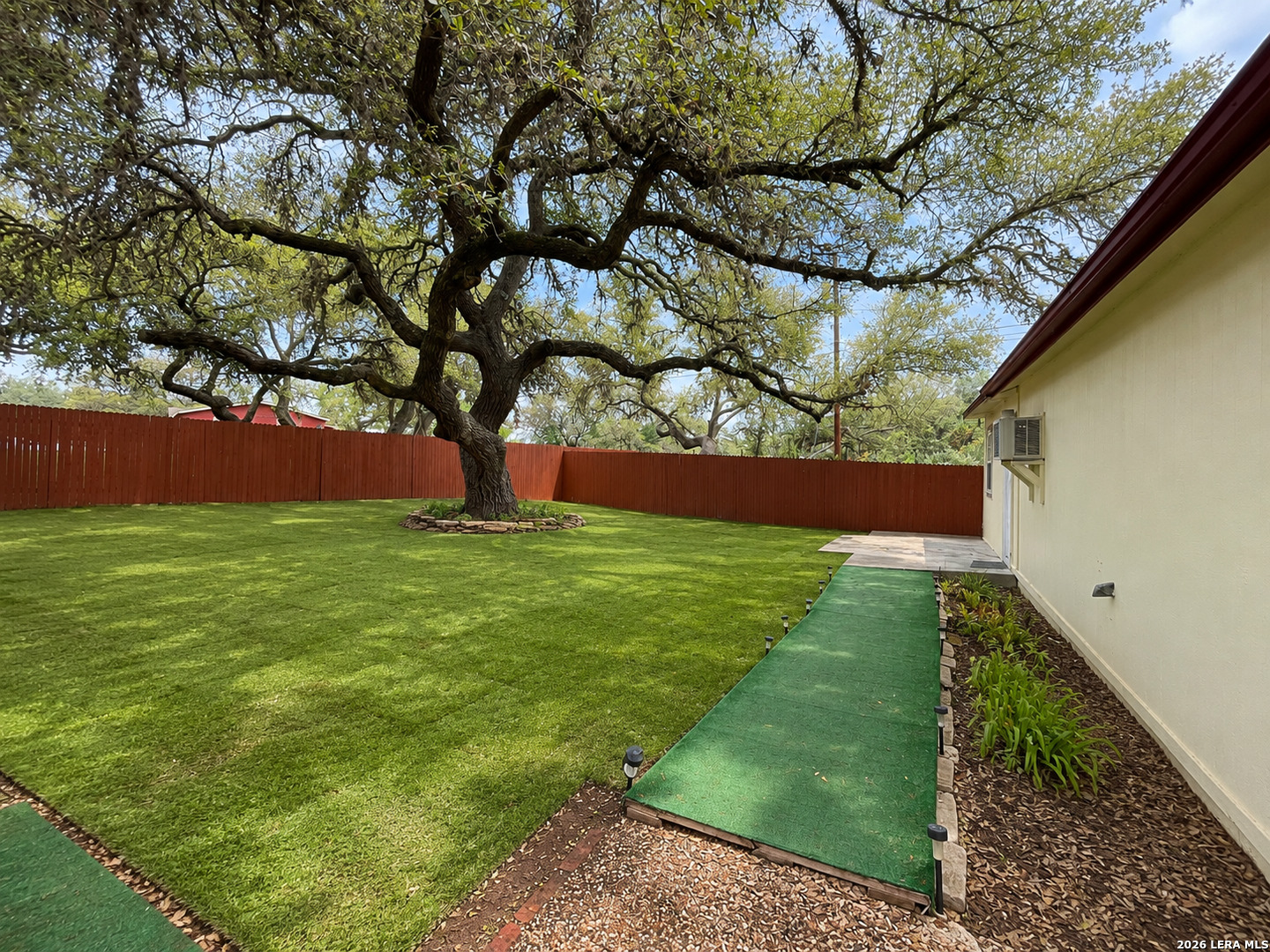 118 Stonegate South, Unit 2 Boerne, TX 78006 - Photo 7 of 7 a backyard of a house with lots of green space