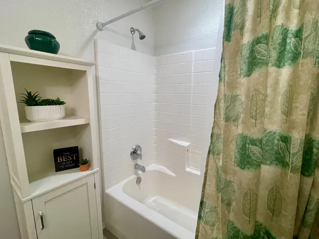 a bathroom with a tub and shower