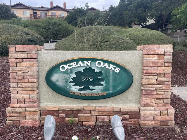 a view of a wooden wall with building in the background