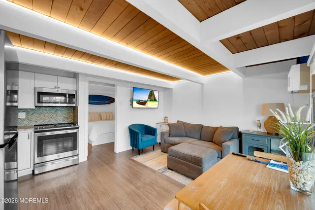 a living room with furniture kitchen view and a fireplace
