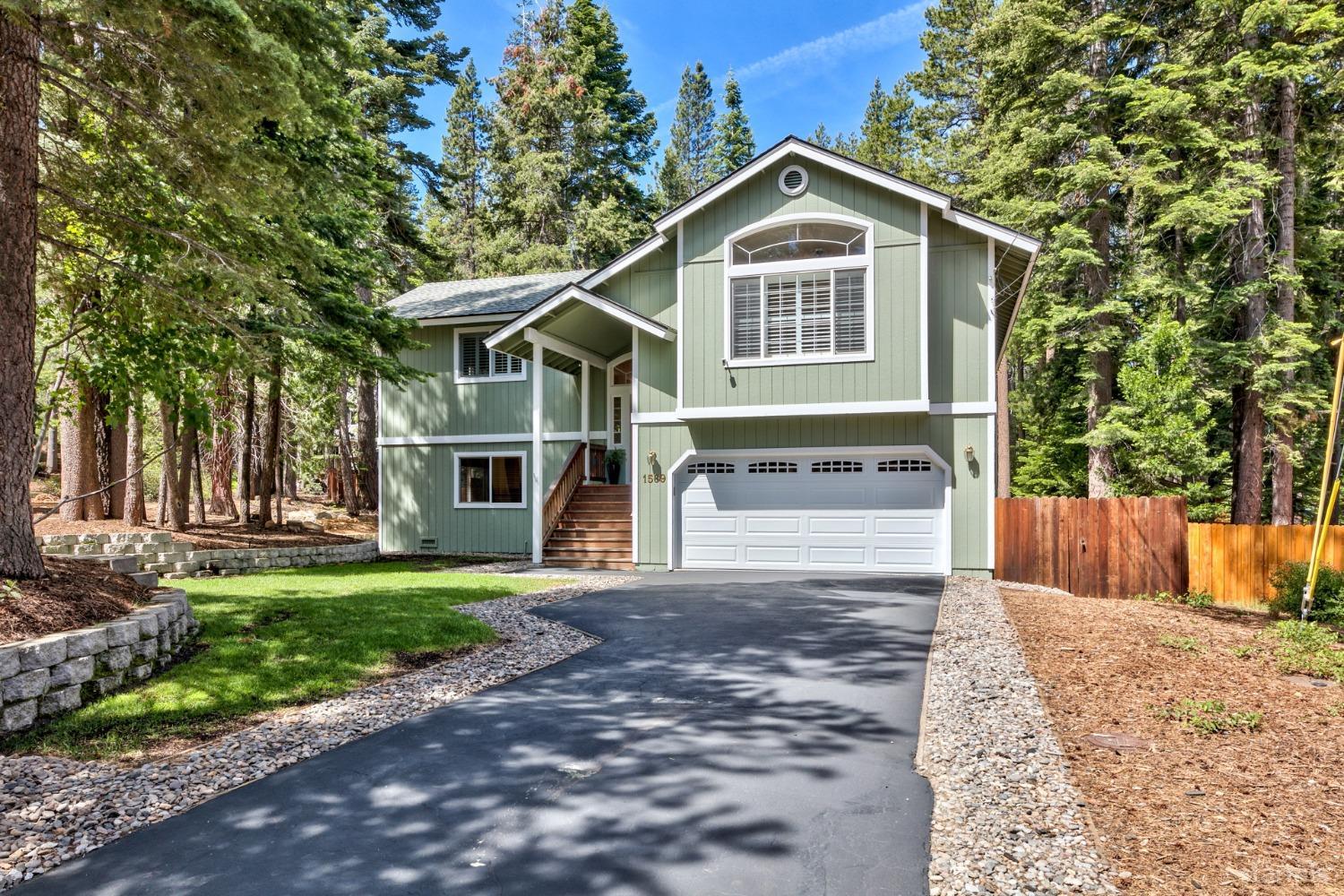 1569 Aztec Way South Lake Tahoe, CA 96150 - Photo 1 of 22 a front view of a house with a yard