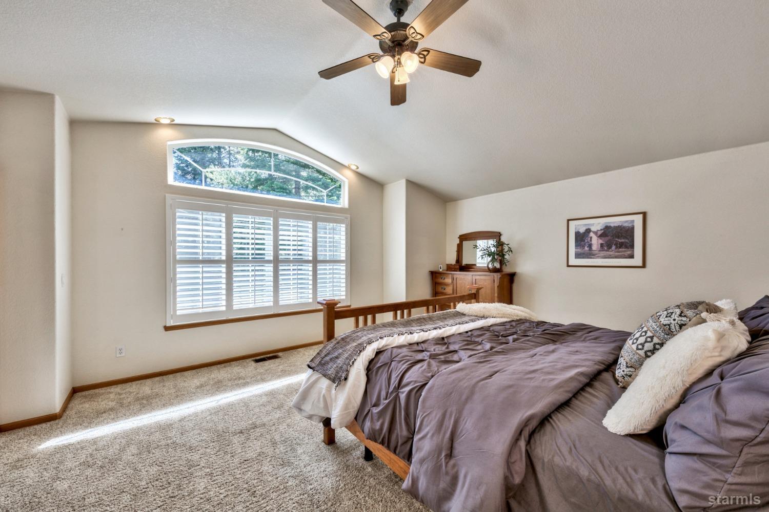 1569 Aztec Way South Lake Tahoe, CA 96150 - Photo 13 of 22 a bedroom with a bed and a large window