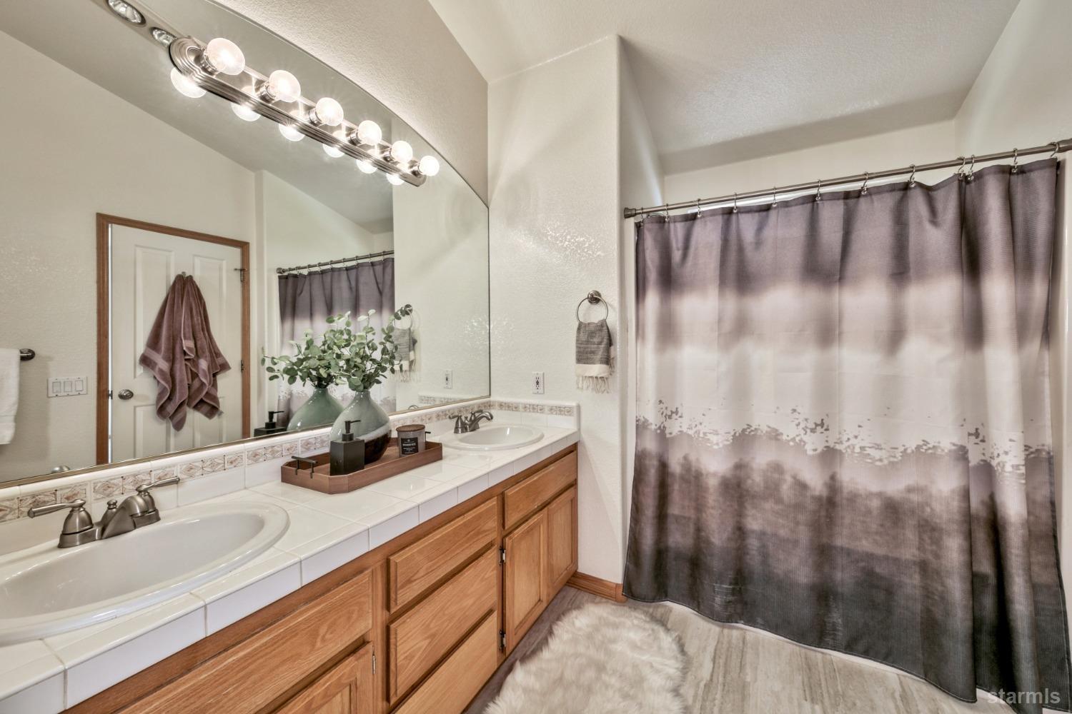 1569 Aztec Way South Lake Tahoe, CA 96150 - Photo 14 of 22 a bathroom with double vanity and a mirror