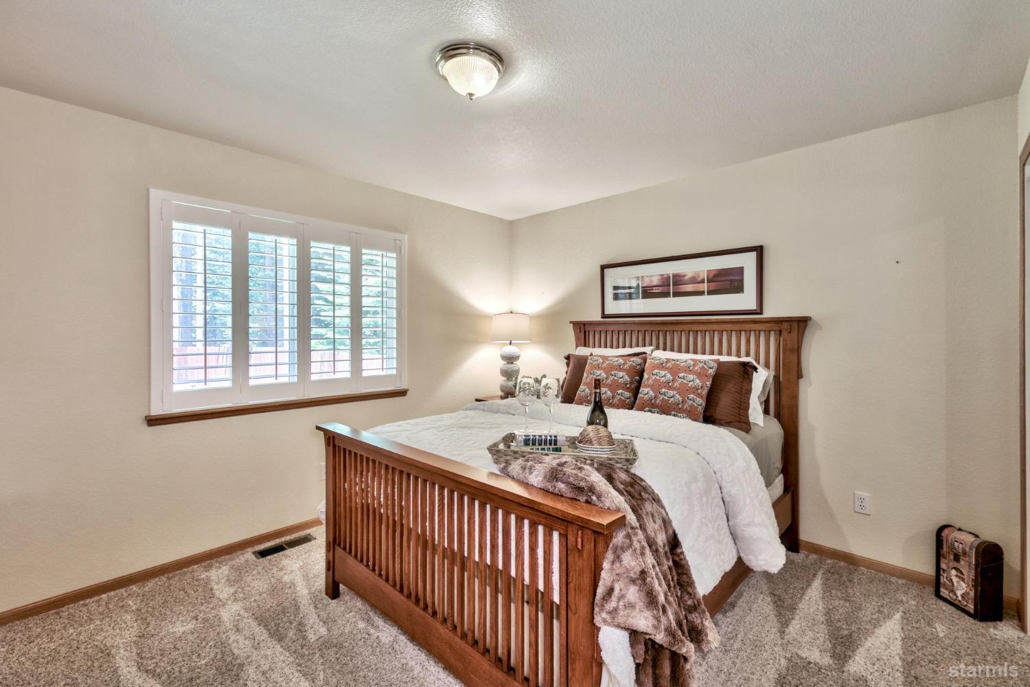 1569 Aztec Way South Lake Tahoe, CA 96150 - Photo 18 of 22 a bedroom with a bed and a window