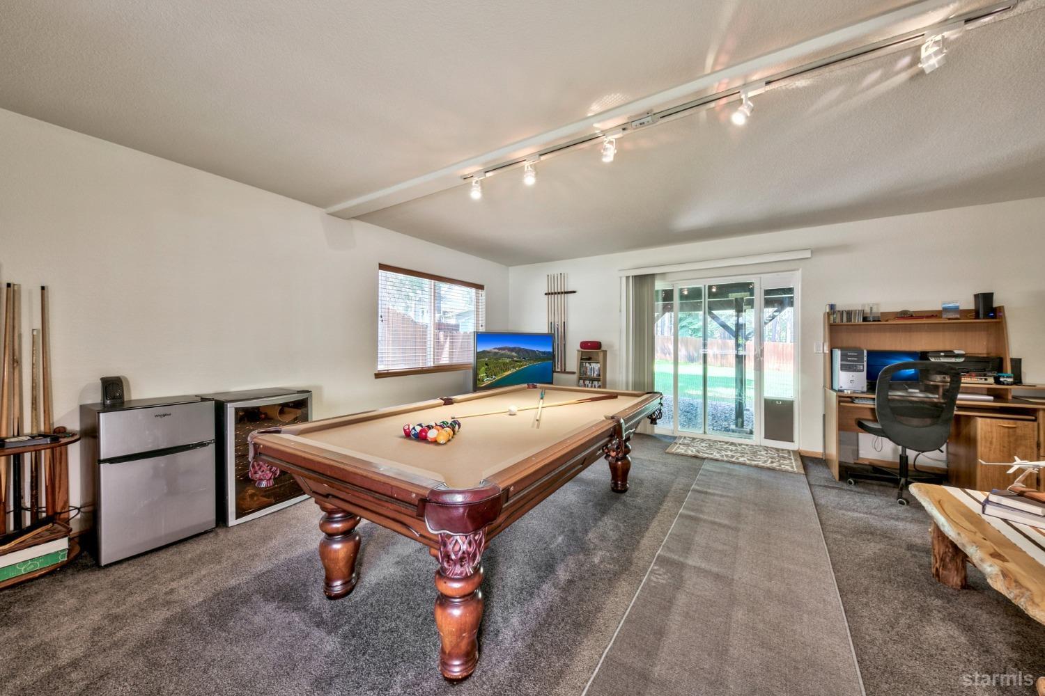 1569 Aztec Way South Lake Tahoe, CA 96150 - Photo 21 of 22 a living room with furniture a flat screen tv and a table