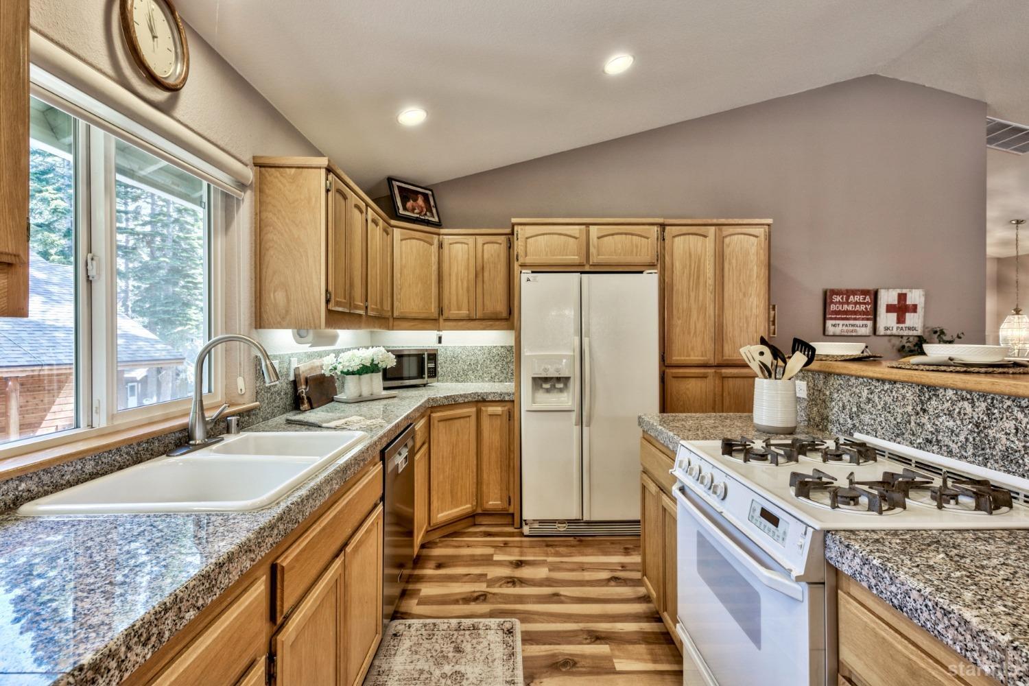 1569 Aztec Way South Lake Tahoe, CA 96150 - Photo 10 of 22 a kitchen with stainless steel appliances granite countertop a sink stove and refrigerator