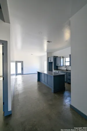 a view of kitchen with refrigerator and window