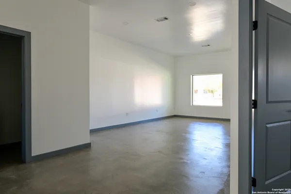an empty room with windows and closet
