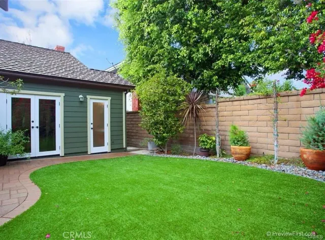 a front view of a house with a yard and green space