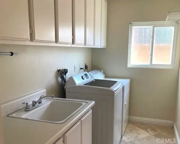 a kitchen with a sink cabinets and a window