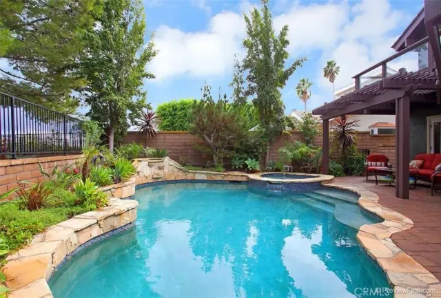 a view of swimming pool with outdoor seating and plants