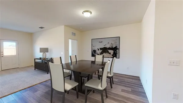 a view of a dining room with furniture and wooden floor