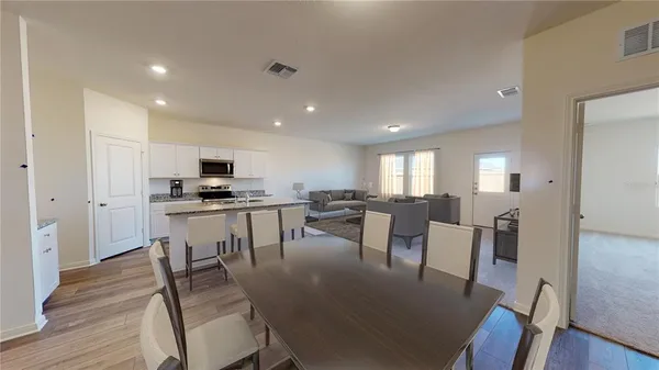a view of a dining room with furniture and wooden floor