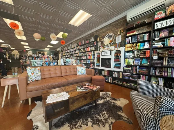a living room with furniture a book shelf and a book shelf