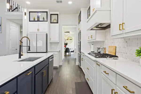 a kitchen with stainless steel appliances granite countertop a sink stove and cabinets