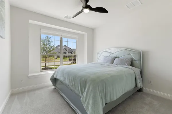 a bedroom with a large bed and a window