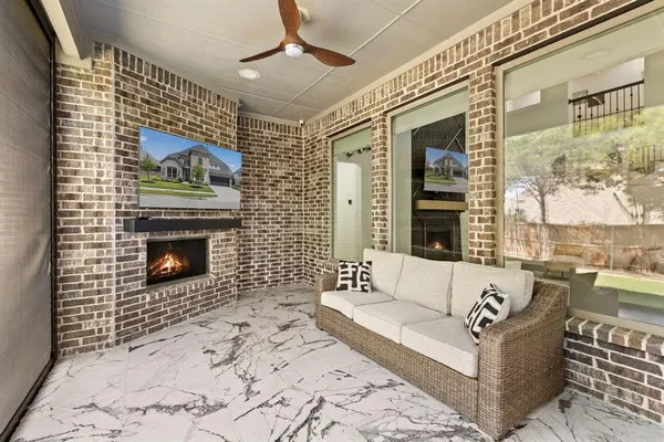 a living room with furniture a flat screen tv and a fireplace