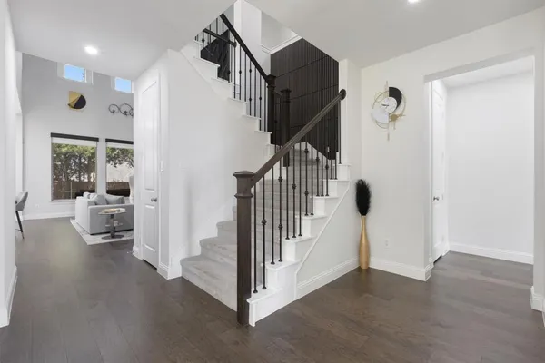 a view of a hallway with a livingroom and entryway
