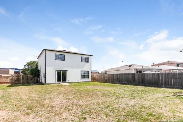 a view of a house with a backyard