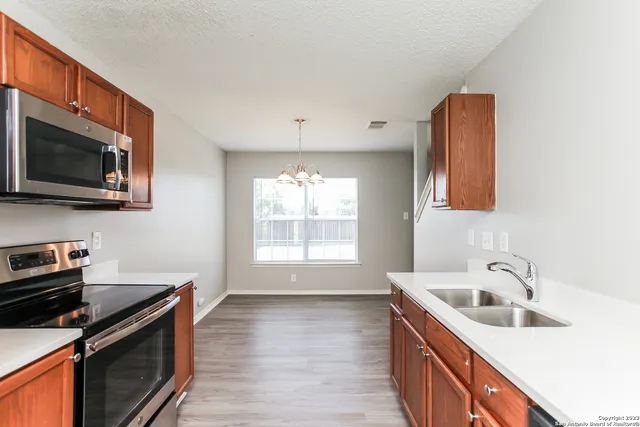a kitchen that has a sink and a stove in it