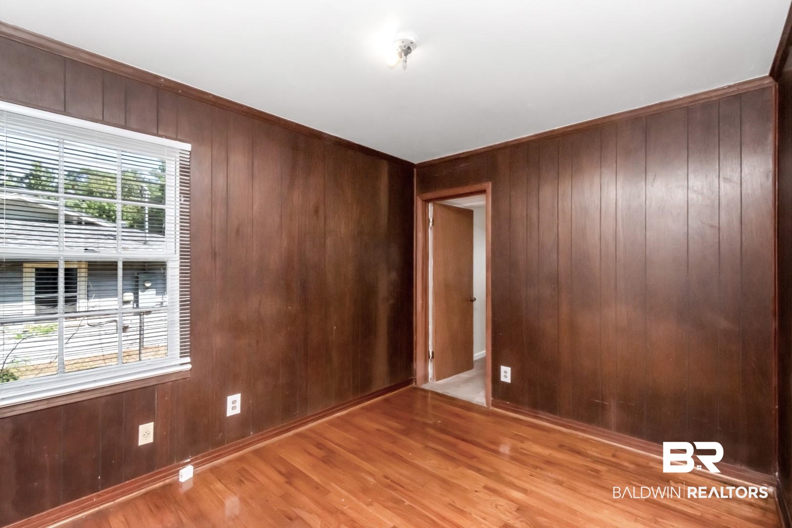 1477 Fairfield Street Mobile, AL 36606 - Photo 26 of 34 Empty room with wood walls and light wood-style floors