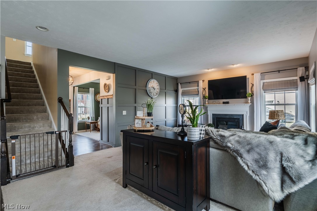 6687 List Street Northwest Canton, OH 44708 - Photo 5 of 21 Living area featuring a glass covered fireplace and light carpet