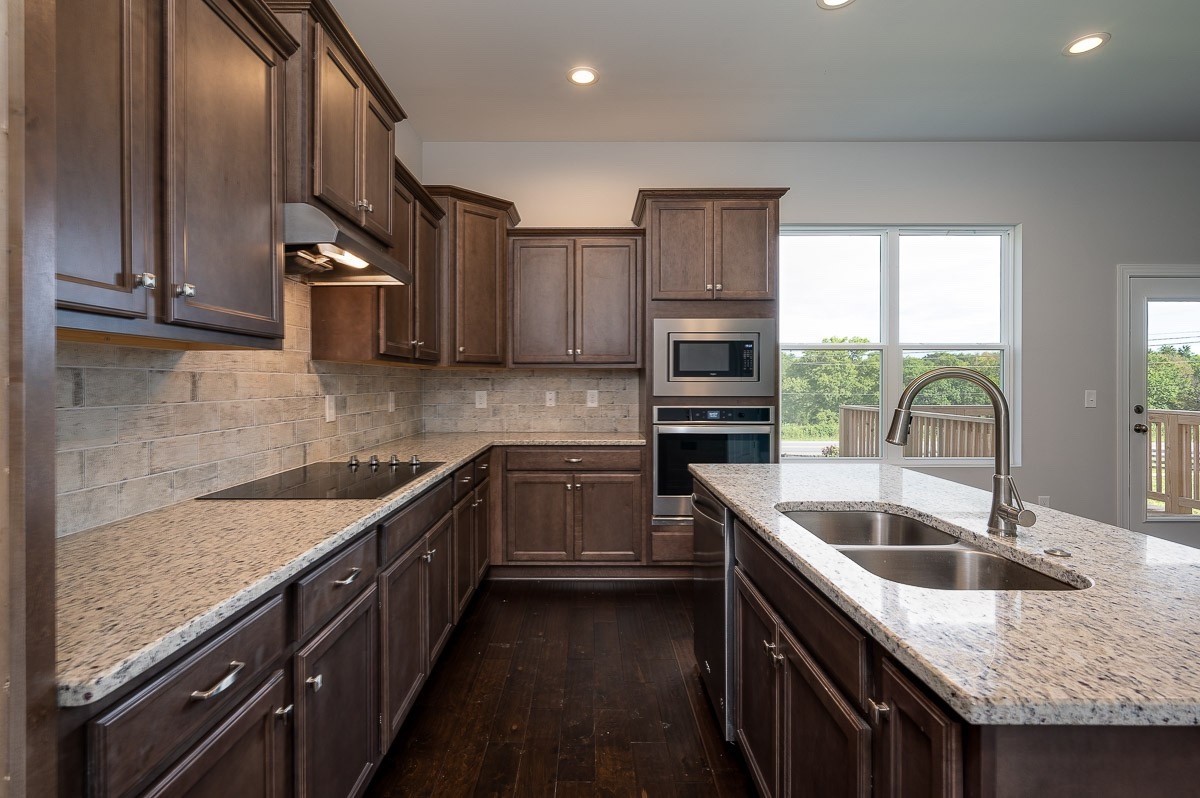 958 Hunters Lane Springfield, TN 37172 - Photo 10 of 11 a kitchen with stainless steel appliances granite countertop a sink a stove and a refrigerator