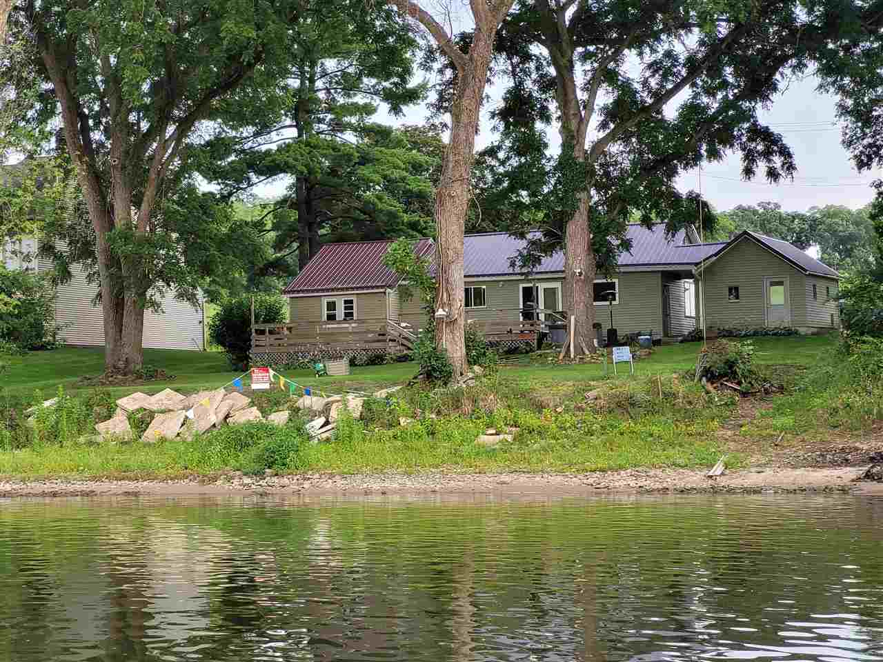 7504 North River Road Byron, IL 61010 - Photo 19 of 46 a front view of a house with a garden and trees