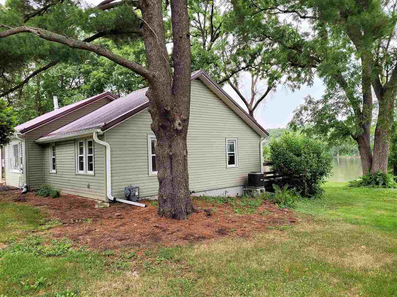 7504 North River Road Byron, IL 61010 - Photo 5 of 46 a view of a house with a yard and trees