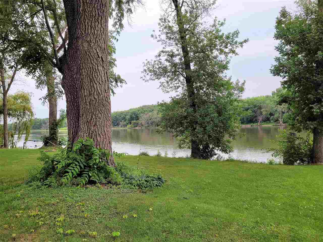 7504 North River Road Byron, IL 61010 - Photo 8 of 46 a view of a lake from a yard