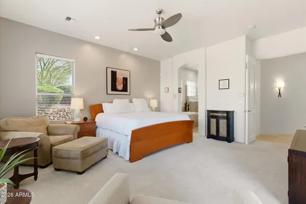 a spacious bedroom with a bed and a couch