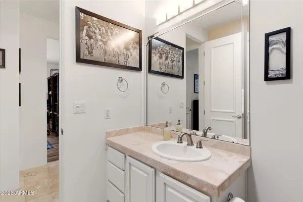 a bathroom with a granite countertop sink and a mirror