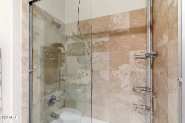 a bathroom with a glass shower door