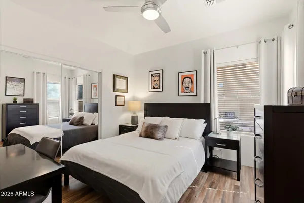 a bedroom with two beds and a window