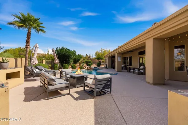 a view of a patio with dining table and chairs with a fire pit