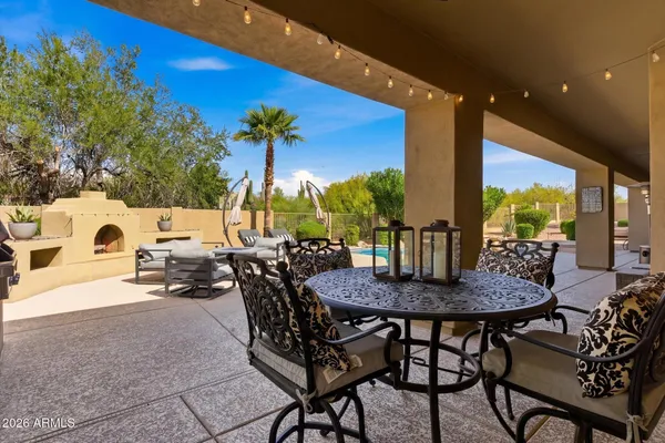 a view of an outdoor dining space with a table and chairs