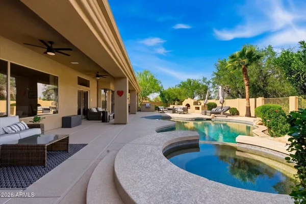 a view of a swimming pool with outdoor seating