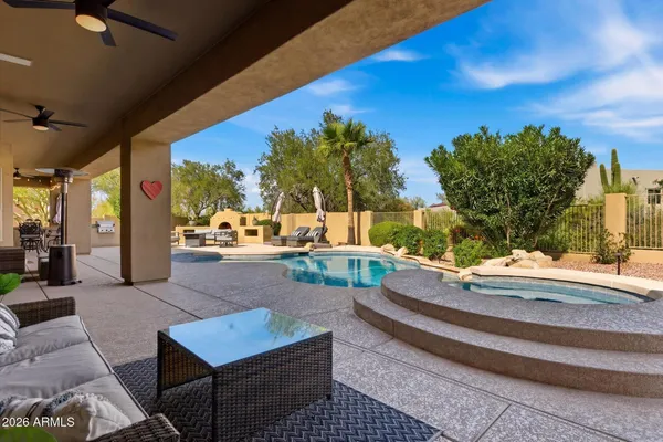 a view of swimming pool with outdoor seating and a yard