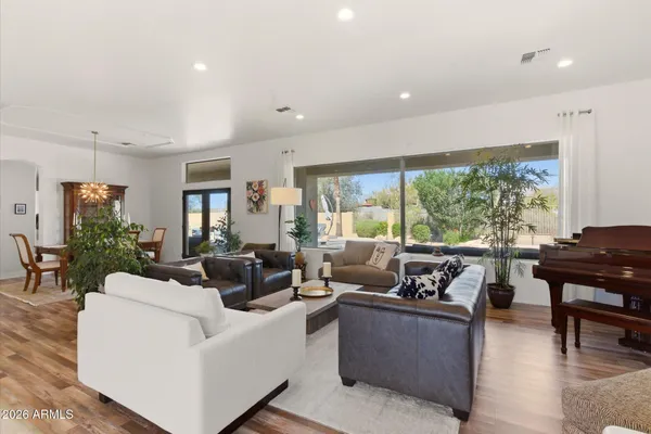 a living room with furniture and large windows