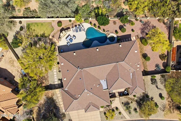 an aerial view of a house with a yard