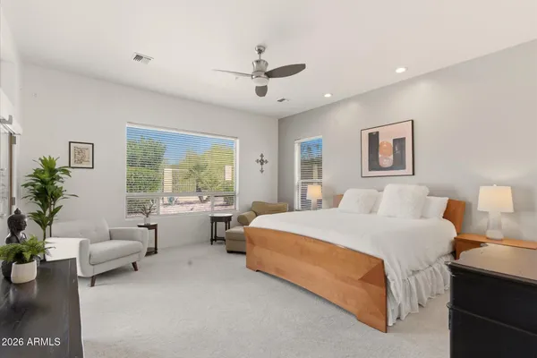 a spacious bedroom with a bed and a couch