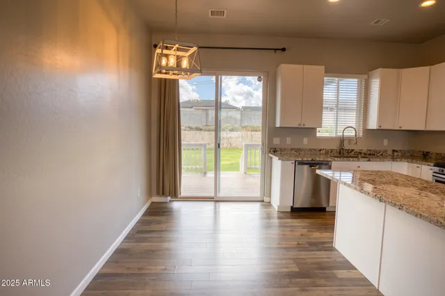 a view of a kitchen with a sink and a window
