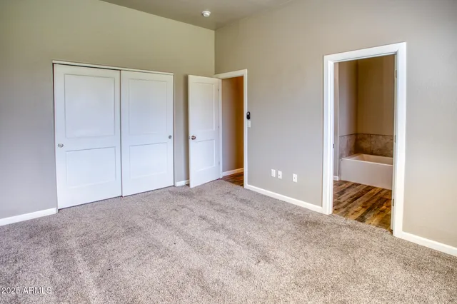 a view of an empty room and bedroom