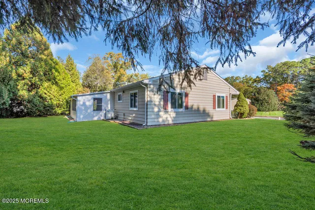 a view of house with backyard