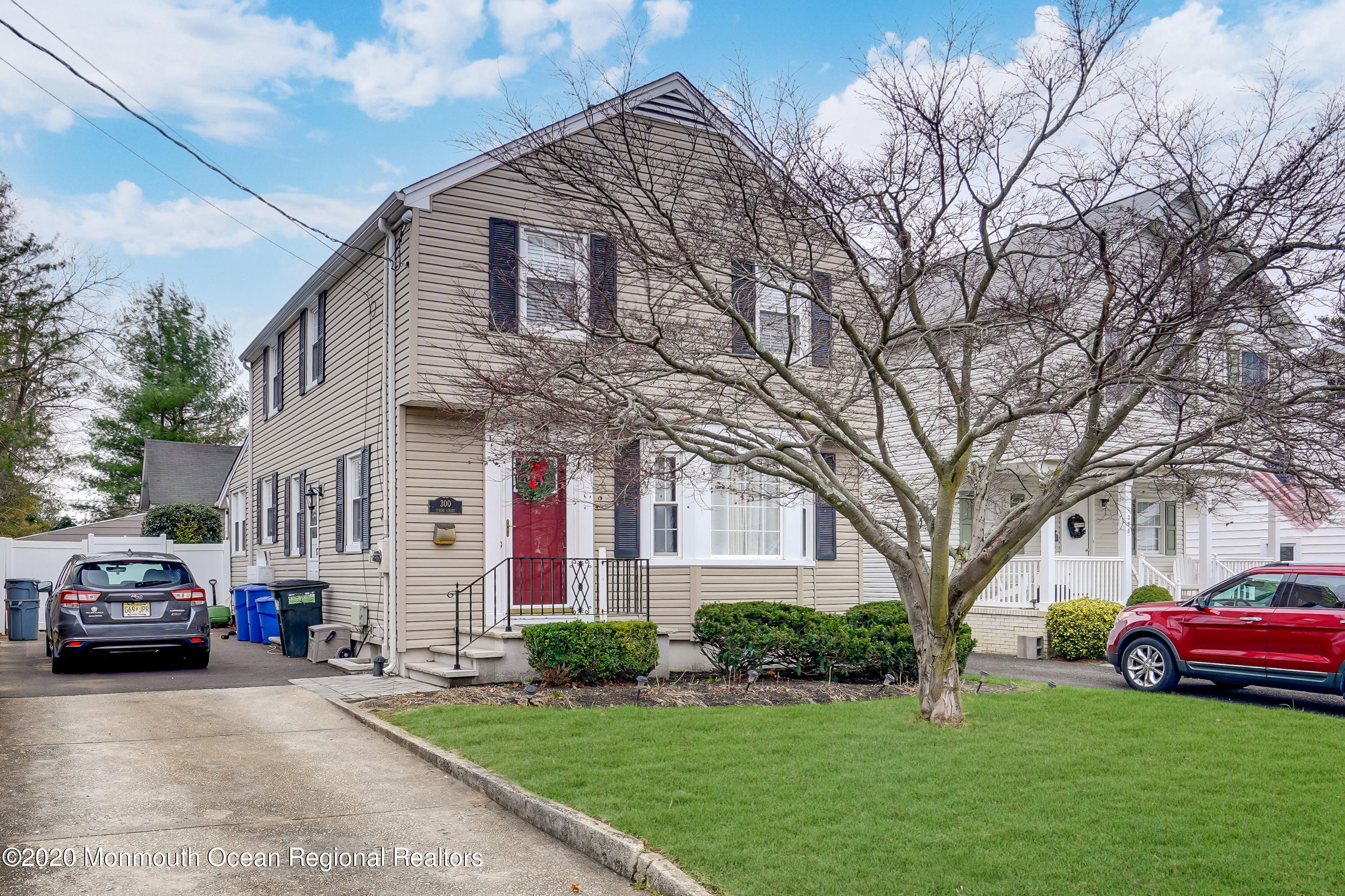 300 Spring Street Red Bank, NJ 07701 - Photo 2 of 25 a front view of a house with a garden and trees